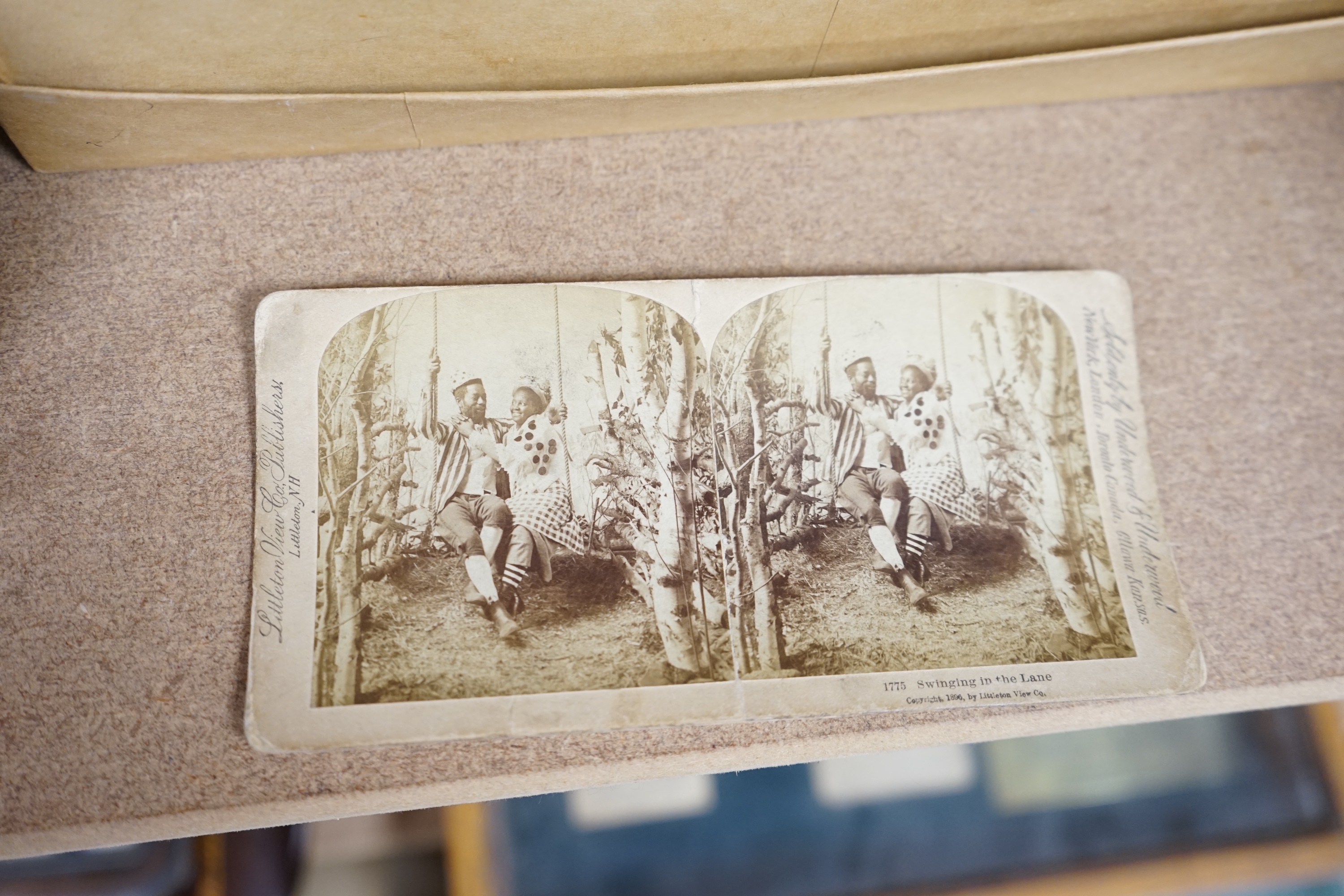 A Cook's patent stereoscope viewer and viewing cards together with a green Morocco leather playing cards box, box 12.5cm high x 24cm wide. Condition, games box poor, viewer and cards good